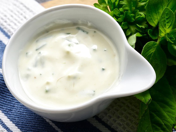 bowl of white sauce with flecks of green