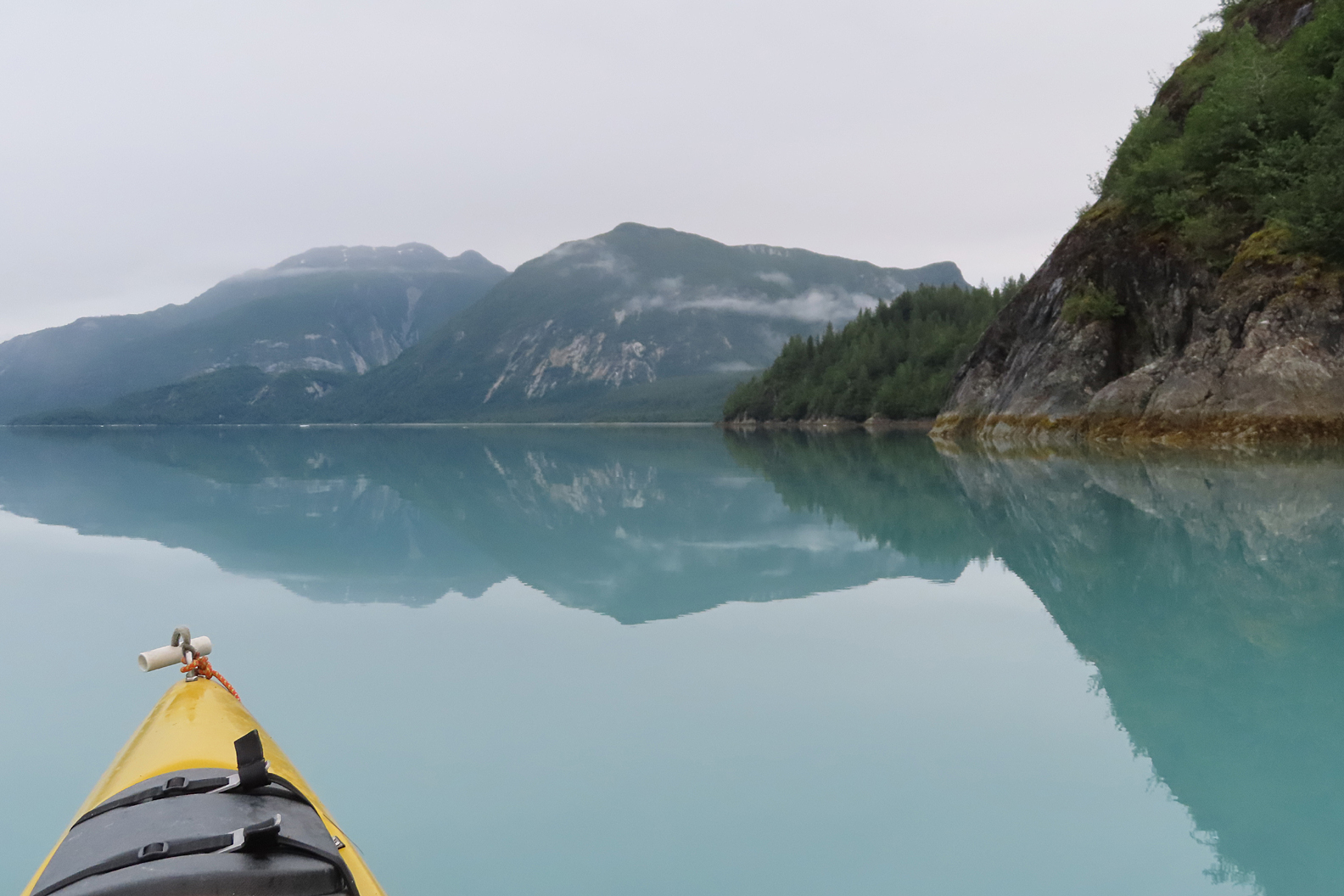 kayaking in glacier bay national park remote bay, mirror like reflective water