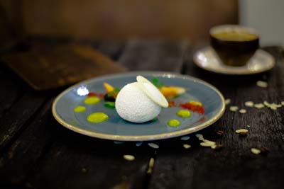 white round cookie ball on a plate with sauce dots