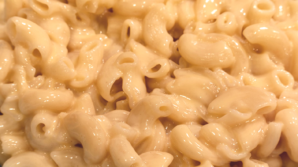 close up creamy orangy vegan macaroni and cheese