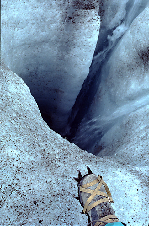 Crampon iceboot on foot by glacier pool
