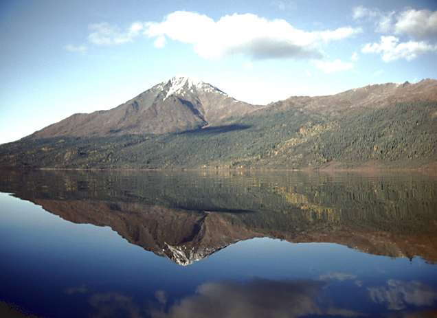reflection of mountain and hills with blue sky in alaska