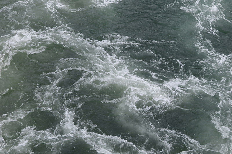 dark green and white water churning like marble