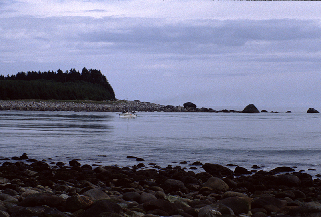 Lituya Bay entrance with boat coming in between rocks